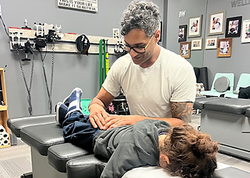 Dr. Raphael, DC - BEYOND WELLNESS CHIROPRACTIC - Brampton, ON Chiropractors - Doctor Working Image