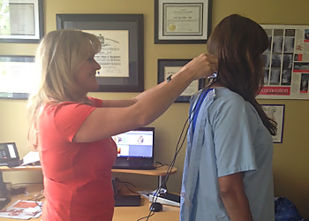 Dr. Carol Reddin, DC - MINORU CHIROPRACTIC - Richmond, BC Chiropractors - Doctor Working Image