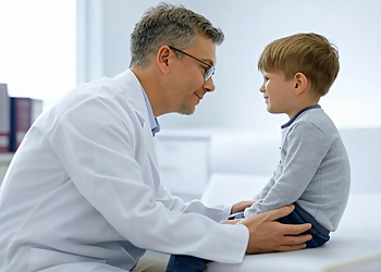Dr. M.K. Mulera - Newmarket, ON Pediatricians - Doctor With Patient Image