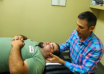 Dr. Nik Dukovac - FAIRWAY CHIROPRACTIC CENTRE - Kitchener, ON Chiropractors - Doctor Working Image