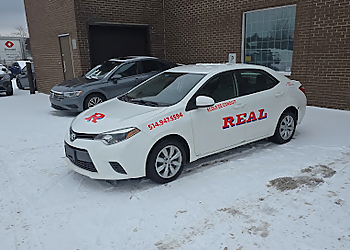 Real Driving School - Dollard des Ormeaux, QC écoles de conduite - Driving Car Image